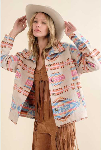 Woman wearing Ivory Blue & Pink Aztec Button Up Jacket.